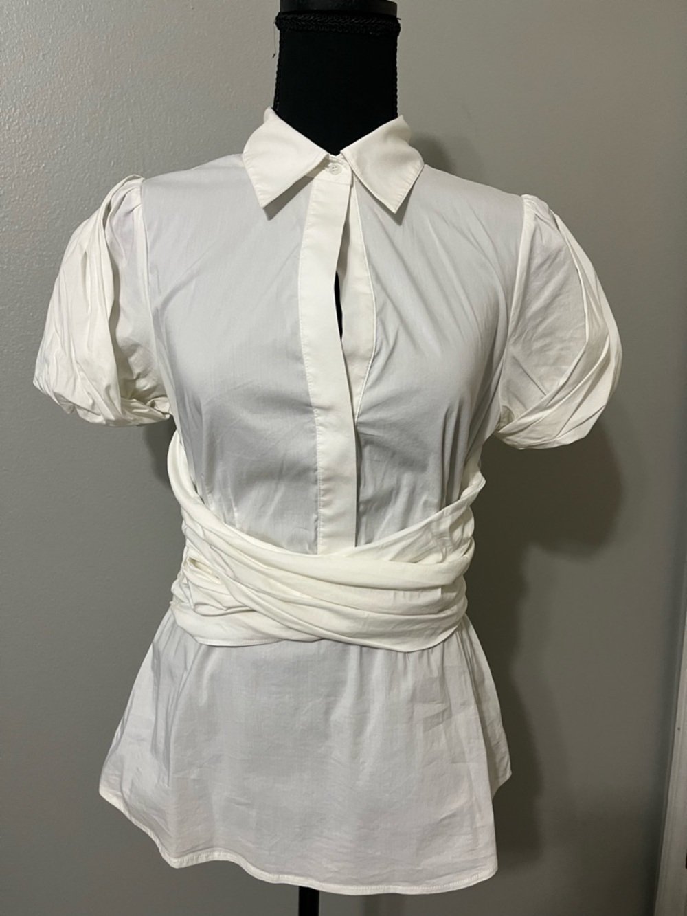 BCBGMaxazria bone white blouse. Pre-Owned Condition-Good. Size M.